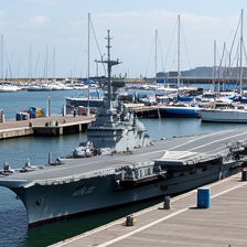 Aircraft carrier at a harbor dock